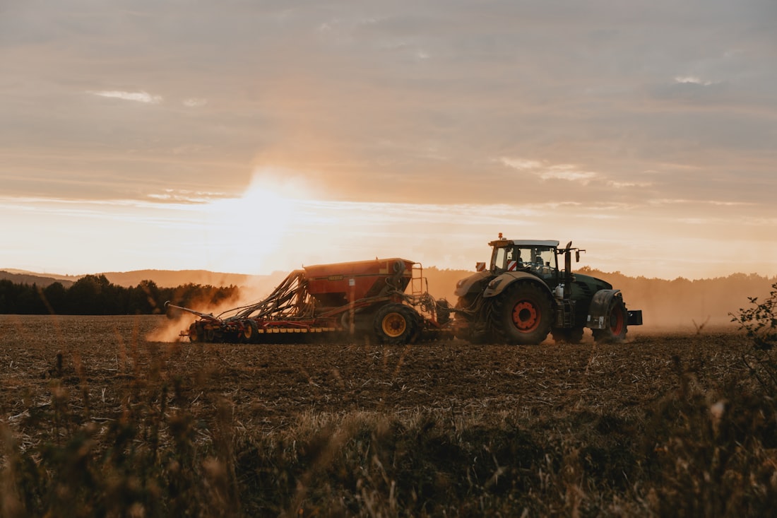 Tractor working a field at golden sunset